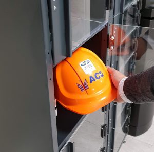 A user collecting an item from the smart locker system Q-lock.